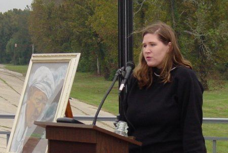 Woman speaking about the painting of George West